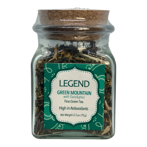 a glass jar filled with green mountain tea.