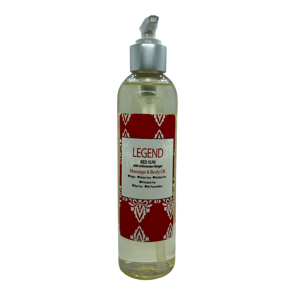 Red sun massage & body oil bottle on white surface.