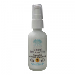 A spray bottle with a white label that reads "Mineral Face Sunscreen SPF 30" is placed on a white surface